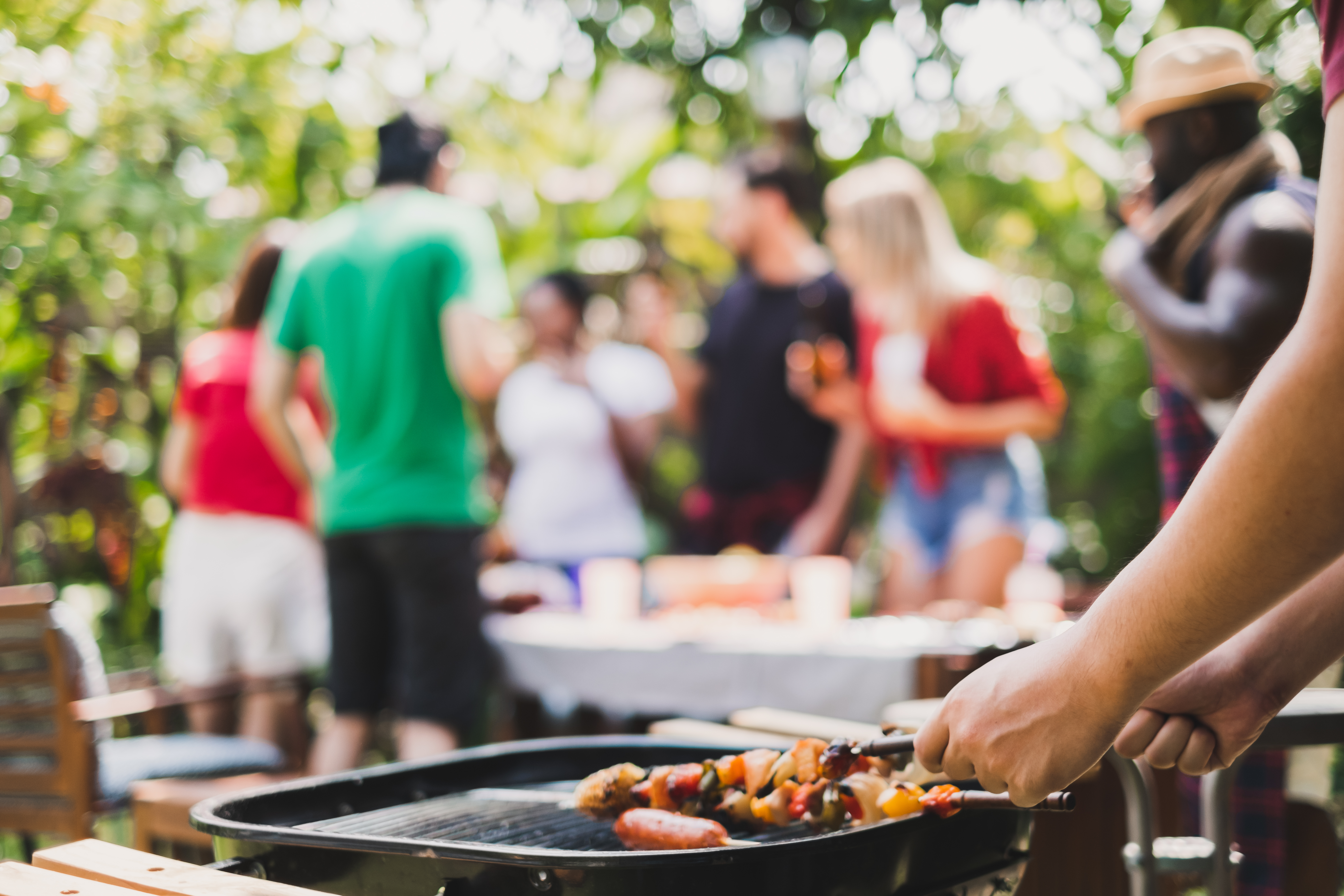 A barbecue grill and people celebrating at a clean and sober recovery event.